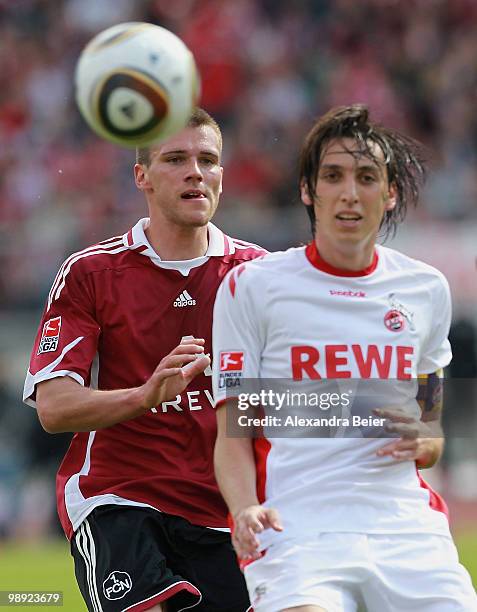 Christian Eigler of Nuernberg fights for the ball with Pedro Geromel of Koeln during the Bundesliga match between 1. FC Nuernberg and 1. FC Koeln at...