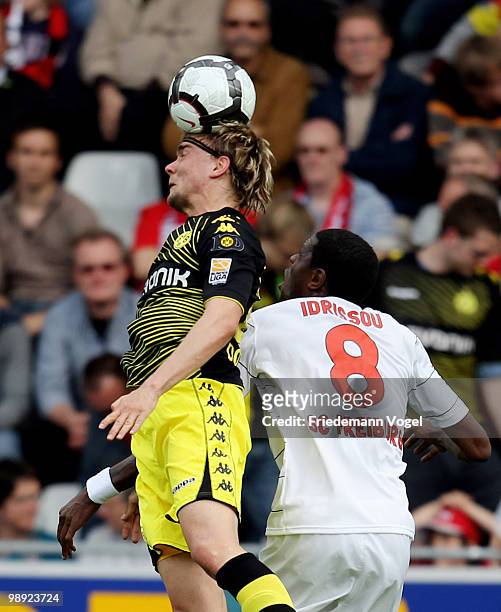 Marcel Schmelzer of Dortmund and Mohamadou Idrissou of Freiburg jump for a header during the Bundesliga match between SC Freiburg and Borussia...