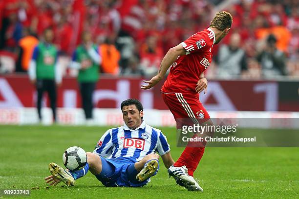 Gojko Kacar of Berlin sits on the pitch after Diego Contento of Bayern tackled him during the Bundesliga match between Hertha BSC Berlin and FC...
