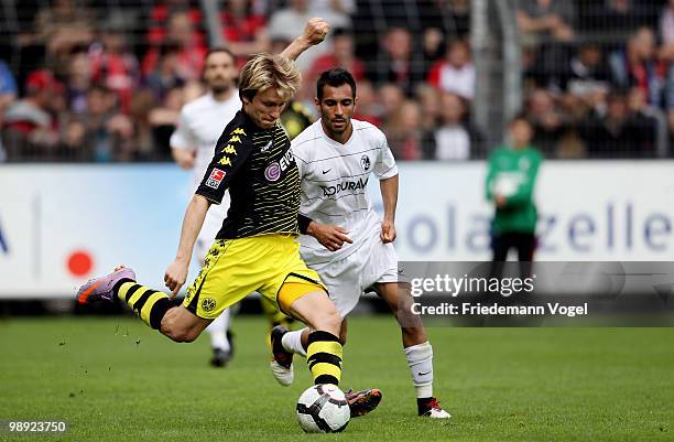 Jakub Blaszczykowski of Dortmund battles for the ball with Yacine Abdessadki of Freiburg during the Bundesliga match between SC Freiburg and Borussia...