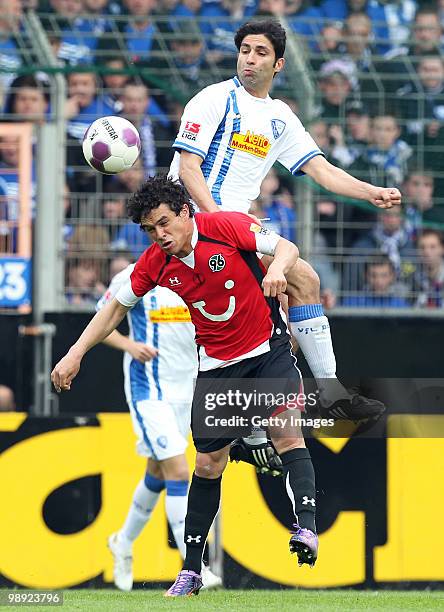 Manuel Schmiedebach of Hannover and Vahid Hashemian of Bochum jump for a header during the Bundesliga match between VfL Bochum and Hannover 96 at...