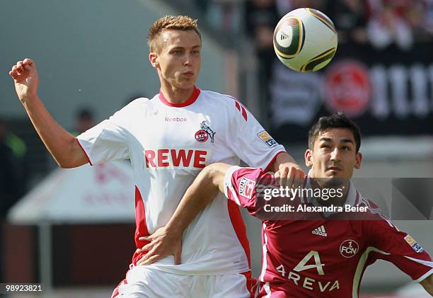 Ilkay Guendogan of Nuernberg fights for the ball with Adam Matuschyk of Koeln during the Bundesliga match between 1. FC Nuernberg and 1. FC Koeln at...