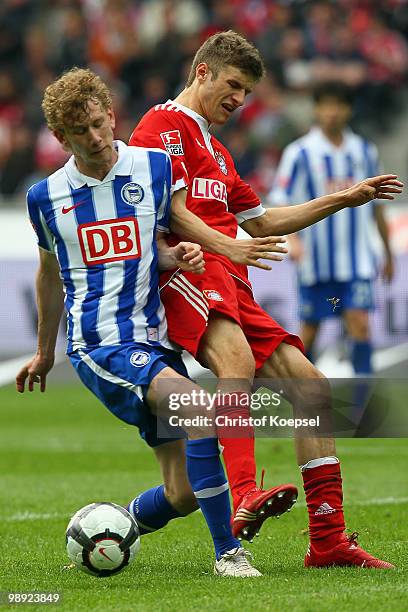 Fabian Lustenberger of Berlin challenges Thomas Mueller of Bayern during the Bundesliga match between Hertha BSC Berlin and FC Bayern Muenchen at...