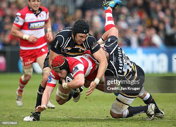 Luke Narraway of Gloucester is upended by Graham Kitchener and Dale Rasmussen of Worcester during the Guinness Premiership match between Worcester...