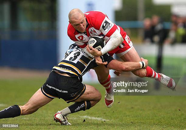 Mike Tindall, captain of Gloucester is tackled by Alex Grove of Worcester during the Guinness Premiership match between Worcester Warriors and...