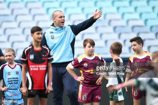 David Klemmer takes part in a juniors coaching clinic during the New South Wales Blues State of Origin Team Announcement at ANZ Stadium on July 2,...