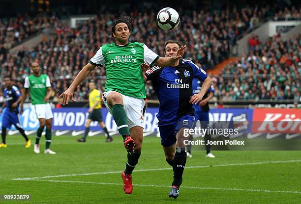 Joris Mathijsen of Hamburg and Claudio Pizarro of Bremen battle for the ball during the Bundesliga match between SV Werder Bremen and Hamburger SV at...