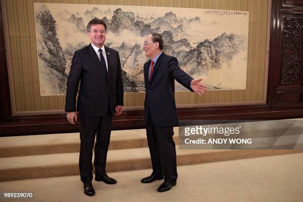 China's Vice President Wang Qishan gestures to president of the United Nations General Assembly, Miroslav Lajcak , to lead the way before the start...