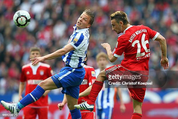 Patrick Ebert of Berlin and Diego Contento of Bayern go up for a header during the Bundesliga match between Hertha BSC Berlin and FC Bayern Muenchen...