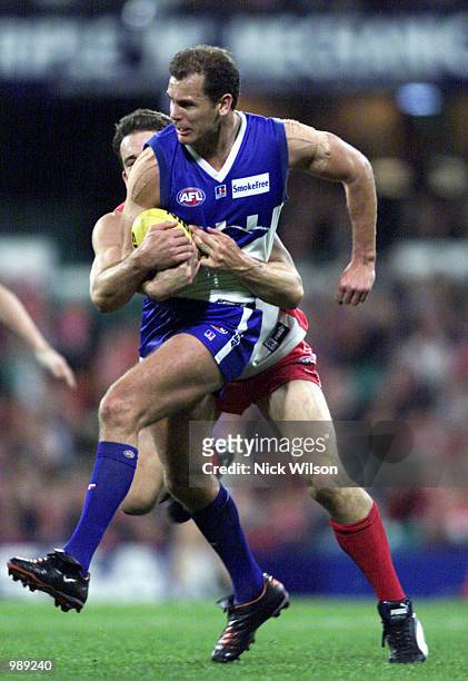 Wayne Carey of the Kangaroo's is tackled by Andrew Dunkley of Sydney during the AFL round 18 match between Sydney Swans and the Kangaroos at the...