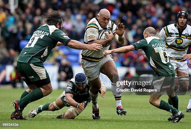 Soane Tonga'uhia of Northampton charges past Faan Rautenbach and Paul Hodson during the Guinness Premiership match between London Irish and...