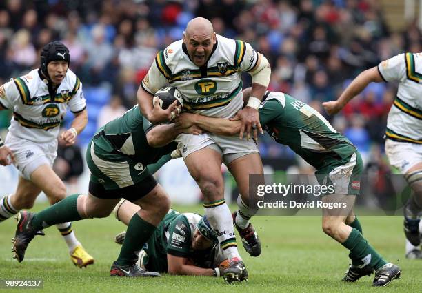 Soane Tonga'uhia of Northampton charges past Faan Rautenbach and Paul Hodson during the Guinness Premiership match between London Irish and...