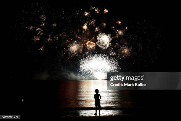 Young girl watches the fireworks display during Territory Day celebrations at Mindil Beach on July 1, 2018 in Darwin, Australia. Every year on July...