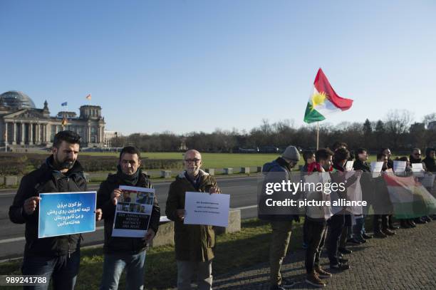 Demonstrators stand in front of the Reichstag, protesting the visit of the premiere of the Kurdistan-Iraq region, Barzani, with German chancellor...