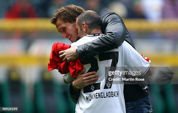 Leverkusen's injured goalkeeper Rene Adler comforts Oliver Neuville of Gladbach after the Bundesliga match between Borussia Moenchengladbach and...