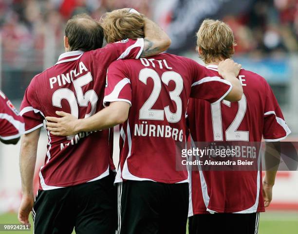 Javier Pinola, Andreas Ottl and Marcel Risse of Nuernberg celebrate Ottl's first goal during the Bundesliga match between 1. FC Nuernberg and 1. FC...