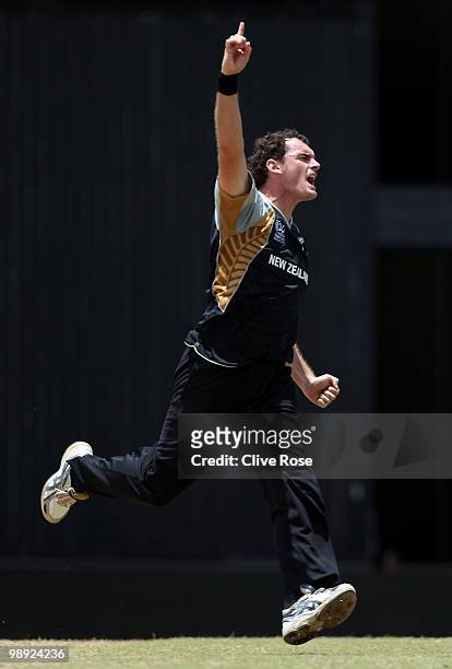Kyle Mills of New Zealand celebrates the wicket of Umar Akmal of Pakistan during the ICC World Twenty20 Super Eight match between New Zealand and...