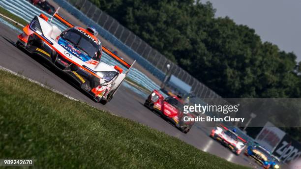 The Acura DPi of Dane Cameron and Juan Pablo Montoya, of Colombia races on the track during the Sahlens Six Hours of the Glen IMSA WeatherTech Series...