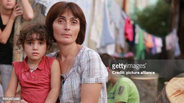 Picture of English teacher Tamar Janelidse, wife of cone picker Michail Murusidse, and their children, taken in the Racha-Lechkhumi district in...