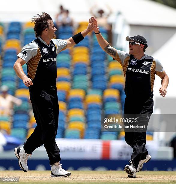 Shane Bond and Brendon McCullum of New Zealand celebrate the dismissal of Mohammad Hafeez during The ICC World Twenty20 Super Eight match between New...