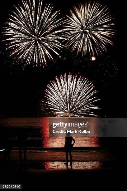 Young girl watches the fireworks display during Territory Day celebrations at Mindil Beach on July 1, 2018 in Darwin, Australia. Every year on July...