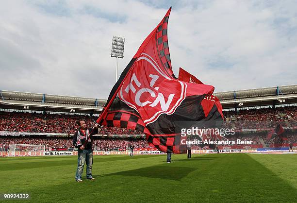 Fan of Nuernberg waves a flag to support his team before the Bundesliga match between 1. FC Nuernberg and 1. FC Koeln at Easy Credit Stadium on May...