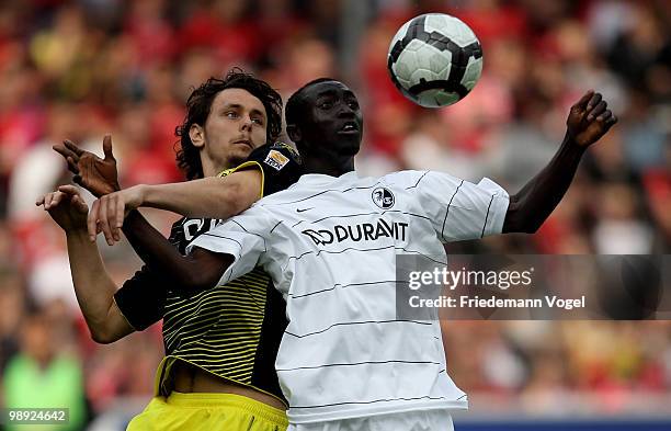 Neven Subotic of Dortmund fights for the ball with Papiss Cisse of Freiburg during the Bundesliga match between SC Freiburg and Borussia Dortmund at...