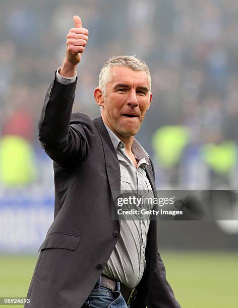 Head coach Mirko Slomka of Hannover celebrates after the Bundesliga match between VfL Bochum and Hannover 96 at Rewirpower Stadium on May 8, 2010 in...