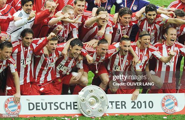 Bayern Munich celebrate with the Bundesliga trophy after the German first division Bundesliga football match Hertha BSC vs FC Bayern Munich in Berlin...