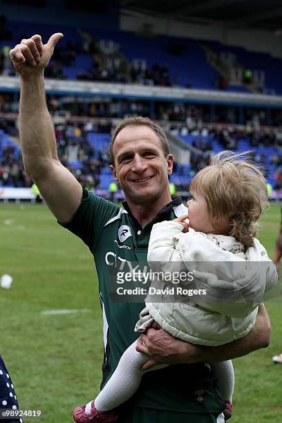 Mike Catt, of London Irish, carrying his daughter Erin, waves to the crowd after his final match after the Guinness Premiership match between London...