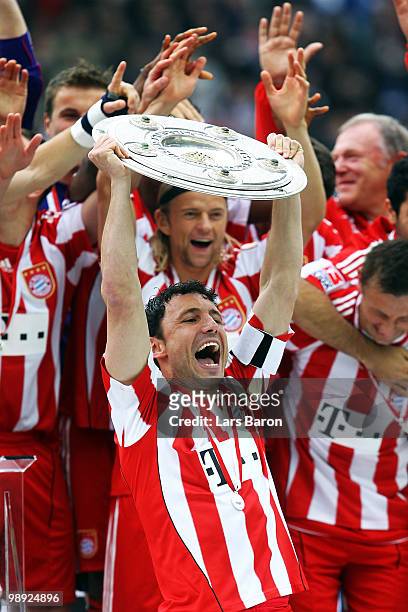 Captain Marc van Bommel of Muenchen lifts the trophy after the Bundesliga match between Hertha BSC Berlin and FC Bayern Muenchen at Olympic Stadium...