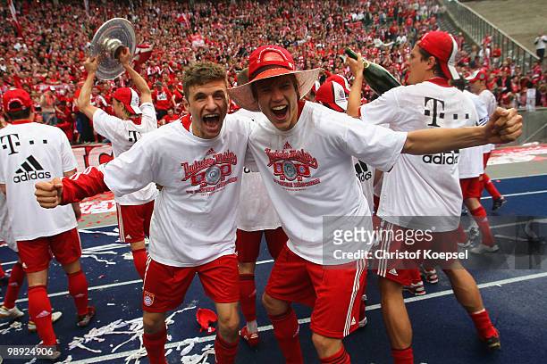 Thomas Mueller and Holger Badstuber of Bayern celebrate winning the German Champions trophy during the Bundesliga match between Hertha BSC Berlin and...