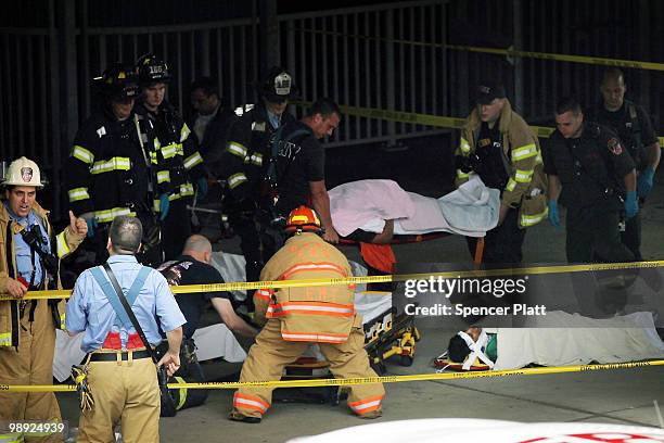 The injured wait to be placed on an ambulance following the crash of the Staten Island Ferry into a dock in the city's borough of Staten Island on...