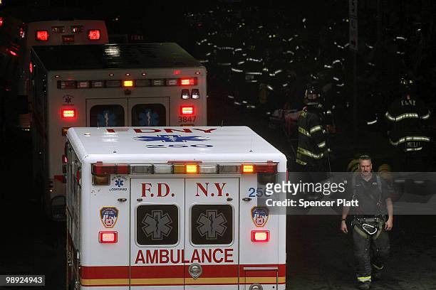 Dozens of firefighters attend to the injured following the crash of the Staten Island Ferry into a dock in the city's borough of Staten Island on May...