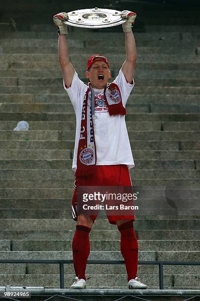 Bastian Schweinsteiger of Muenchen lifts the trophy after the Bundesliga match between Hertha BSC Berlin and FC Bayern Muenchen at Olympic Stadium on...