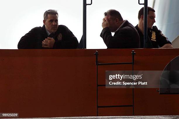 Investigators stand on the Andrew J. Barbieri ferry following the crash of the Staten Island Ferry into a dock in the city's borough of Staten Island...