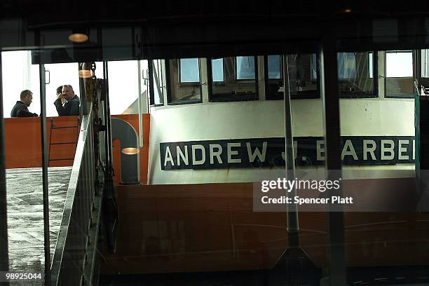 Investigators stand on the Andrew J. Barbieri ferry following the crash of the Staten Island Ferry into a dock in the city's borough of Staten Island...