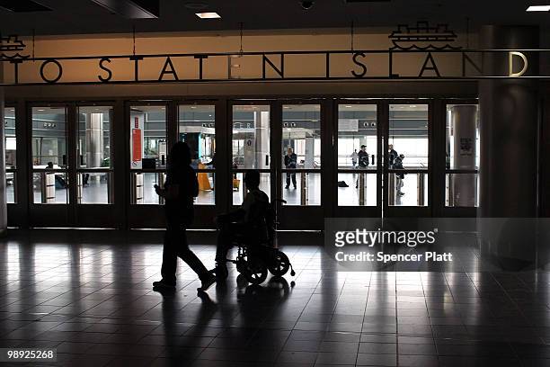 Passengers pass the entrtance to the Staten Island Ferry following the crash of the Staten Island Ferry into a dock in the city's borough of Staten...