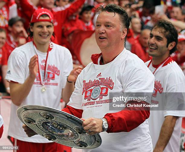 Head coach Louis van Gaal of Bayern holds the German champions trophy after winning 3-1 the Bundesliga match between Hertha BSC Berlin and FC Bayern...