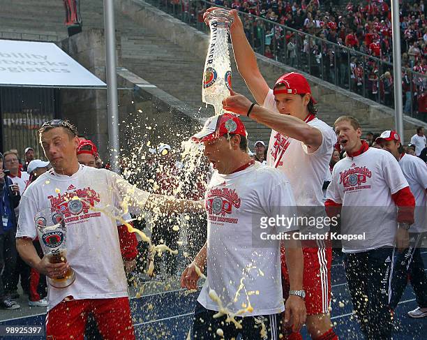 Ivica Olic and Daniel van Buyten of Bayern celebrate winning the German champions trophy after winning 3-1 the Bundesliga match between Hertha BSC...