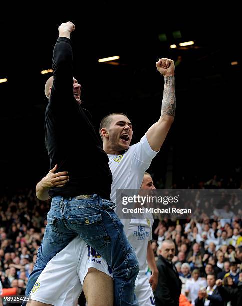 Bradley Johnson of Leeds United celebrates Jermaine Beckford's goal to make it 2-1 with a fan during the Coca Cola League One match between Leeds...