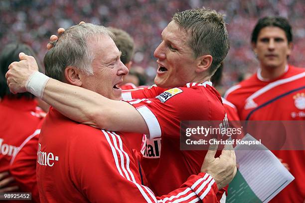 Bastian Schweinsteiger of Bayern embraces assistant coach Hermann Gerland after winning ther German champions trophy after winning 3-1 the Bundesliga...