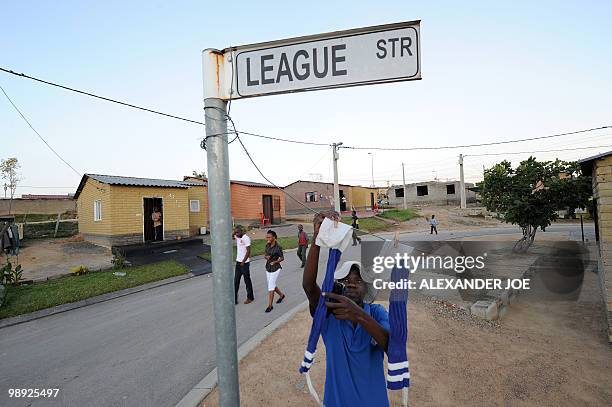 Football player puts socks on the line to dry at the corner of League and Match street, in Alexandra, north of Johannesburg on May 8, 2010. All of...