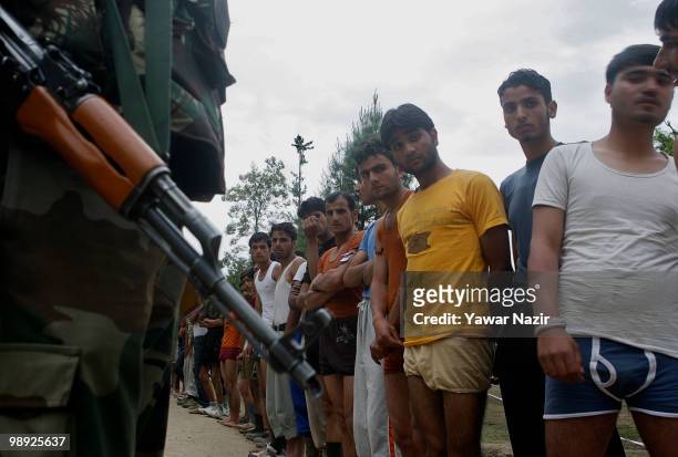 Kashmiri youth subjected to physical test wait for their turn during a recruitment rally on May 08, 2010 near Pakistan border in Wayin, 100 Kms north...