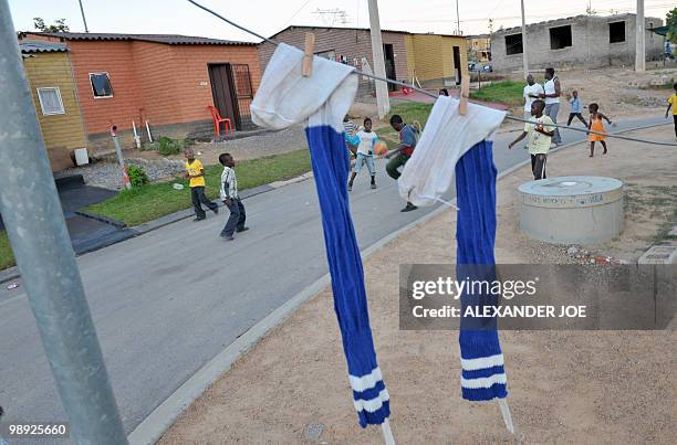 Children play football on the Corner of League and Match street, in Alexandra, north of Johannesburg on May 8, 2010. All of the street in the...