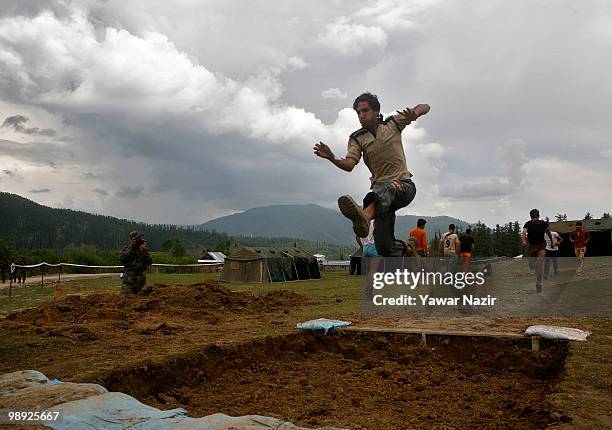 Youth successfully crosses a pit during a recruitment rally on May 08, 2010 near Pakistan border in Wayin, 100 Kms north of Srinagar, the summer...