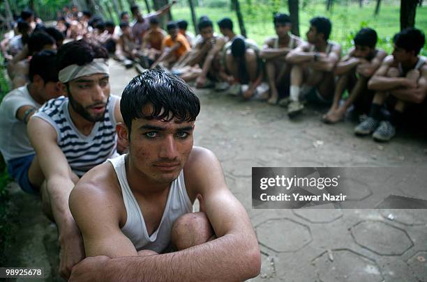 Kashmiri youth subjected to physical test wait for their turn during a recruitment rally on May 08, 2010 near Pakistan border in Wayin, 100 Kms north...