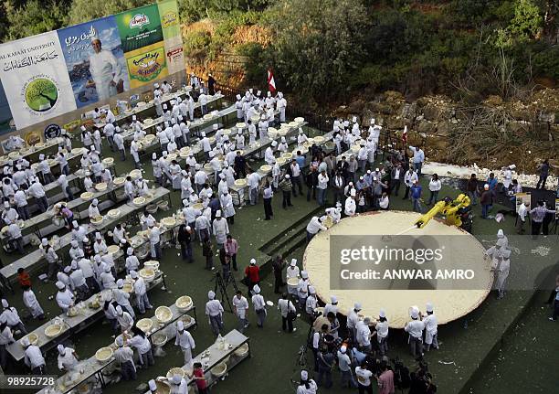 Lebanese chefs prepare the largest plate of hummus to set a new Guinness world record in Beirut on May 8, 2010. The massive hummus serving weighed at...
