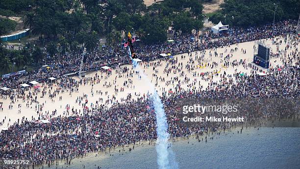 Peter Besenyei of Hungary flies over the huge crowd on Flamengo Beach during the Red Bull Air Qualifying Day on May 8, 2010 in Rio de Janeiro, Brazil.