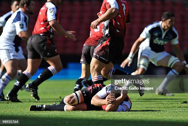 Walter Venter of the Lions lies injured during the Super 14 match between Auto and General Lions and Blues at Coca Cola Park on May 08, 2010 in...